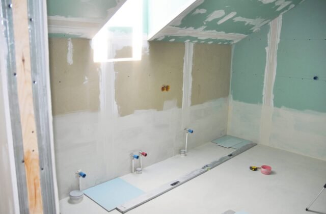 A bathroom remodel in progress under a skylight